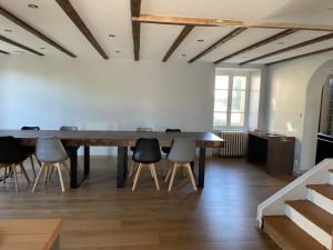 a dining room with a large table and chairs at Grande maison familiale in Tortebesse +16 photos