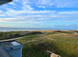 a view of the ocean from the balcony of a house at Moana3 Seaview in Egmond aan Zee