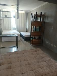 a room with two bunk beds and a shelf at Studio à Beira-mar - Santos in Santos