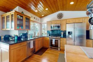 a kitchen with wooden cabinets and stainless steel appliances at Waterfront Retreat at Church Point in Shelton