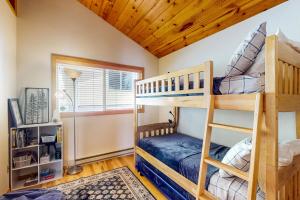 a bedroom with two bunk beds in a house at Waterfront Retreat at Church Point in Shelton