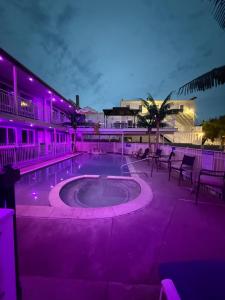 a building with a pool with purple lighting at Twilight Motel in Wildwood