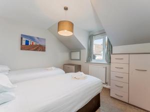 a bedroom with two beds and a window at Golden Coast Leisure Park - Ocean Tide Villa 3 T in Woolacombe