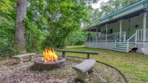 a fire pit in a yard next to a house at The Farmhouse by Avada Properties in Sevierville
