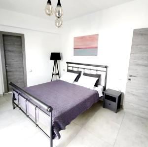 a bedroom with a bed and a lamp in it at Bridge House Corfu in Potamós