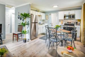 a kitchen with white cabinets and a table and chairs at Hampton Vacation Rental Central Location, Patio in Hampton