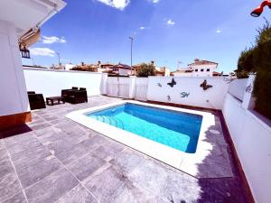 a swimming pool on the roof of a house at Gregorys Poolside Villa in Sucina