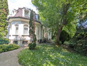 an old house with a tree in front of it at Holiday home in Gardony - Velence-See 20604 in Gárdony