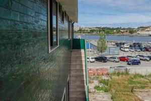 a building with a balcony with a view of a parking lot at Fish Village Apartments II in Vila Nova de Gaia