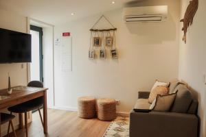 a living room with a couch and a table at Fish Village Apartments II in Vila Nova de Gaia