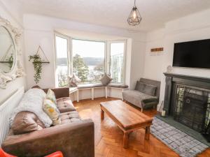 a living room with a couch and a fireplace at Afallon in Menai Bridge