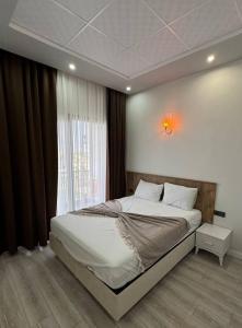 a bedroom with a large bed and a window at SG RESORT Apart Otel in Silifke