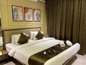 a hotel room with two beds and a window at Kedari Residency in Yeraoda +56 photos
