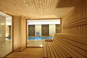a pool in the middle of a room with wooden walls at Iberostar Waves Cala Millor - Adults Only in Cala Millor +44 photos