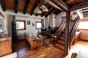a living room with wooden floors and a staircase at Chaletbethere in Pila +106 photos