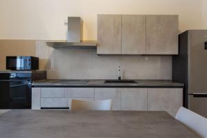 a kitchen with a sink and a counter top at Palazzo Di Paola - Residenza Storica in LʼAquila