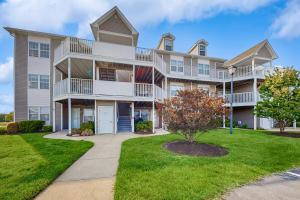 a large apartment building with a green yard at Bethany Bay --- 1004 Pavilion Dr in Ocean View