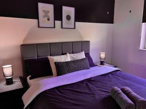 a bedroom with a large purple bed with two lamps at Modern, Central, Haven, 1BR with Balcony in Sheffield
