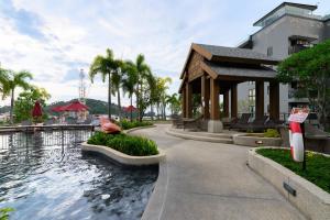 a resort with a swimming pool and a building at Mida Grande Resort 1106 by Phuket Sabay Rent in Ban Lum Fuang