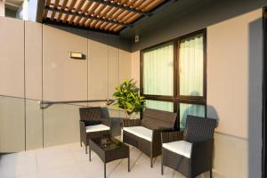 a room with chairs and a table and a window at Mida Grande Resort 1106 by Phuket Sabay Rent in Ban Lum Fuang
