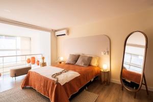 a bedroom with a bed and a large mirror at Private Terrace Duplex in El Poblado in Medellín