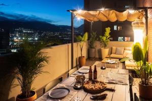 a table on a balcony with a view of the city at Private Terrace Duplex in El Poblado in Medellín