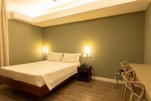 Cama ou camas em um quarto em Savassi Hotel