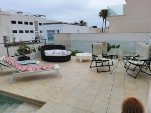 a patio with chairs and a table on a balcony at Villa Marjal in Guardamar del Segura