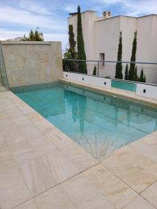 a swimming pool in the middle of a building at Villa Marjal in Guardamar del Segura