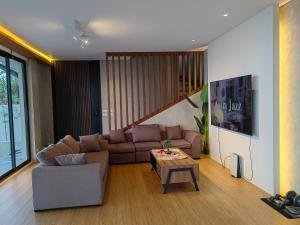 a living room with a couch and a table at The LakeFront Villa in Binangonan +7 photos