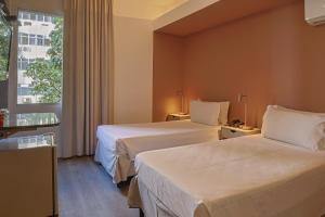 Cama ou camas em um quarto em Savassi Hotel