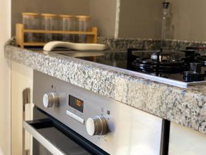 a kitchen with a stove and a counter top at Northgate Apart-Villa in Shkodër