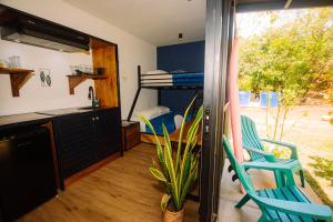 a bedroom with a bunk bed and two blue chairs at Wao Jungle Venao in Playa Venao
