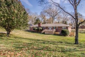 a house in a field with a yard at The Graycroft by Stay Local Nashville in Nashville