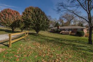 a house with a wooden fence in a yard at The Graycroft by Stay Local Nashville in Nashville