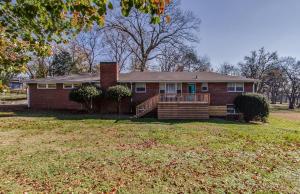 a red brick house with a porch on a yard at The Graycroft by Stay Local Nashville in Nashville +37 photos