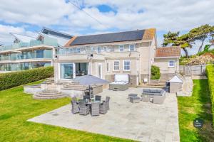 a house with solar panels on the roof at Comfort Hill - Luxury hot tub sea views in Overcombe
