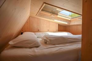 a bedroom with a bed in a wooden room at Tiny House Pioneer 1 - Salemer See in Salem