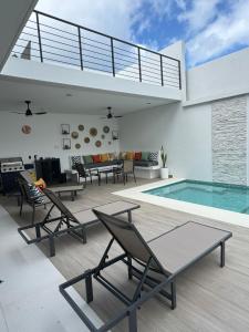 a patio with chairs and a swimming pool at Ocean Dream Apartment E2-A3 in San Juan del Sur