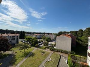 an aerial view of a city with buildings and trees at Kala Sea View Apartments 150m from beach and 250 m from old town in Poreč +10 photos
