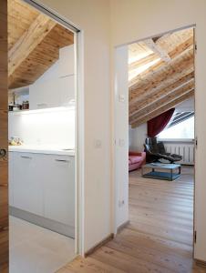 een keuken en woonkamer met witte kasten en houten plafonds bij CanguroProperties - Al Mas 1 in Cojana +18 foto's