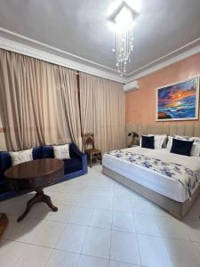 a bedroom with a large bed and a table at ksar el bahja in Marrakech +35 photos