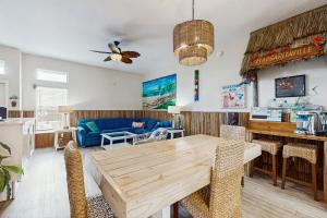a living room with a wooden table and chairs at Tiki House in Corpus Christi