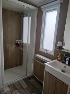 un bagno con doccia e lavandino di mobilhome à la mer a Montreuil-sur-Ille