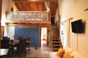 a living room with a table and a tv at Monte D´Sancho in Aljezur