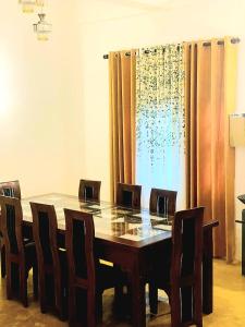 a dining room table with chairs and a large window at 07th Heaven Villa in Tangalle