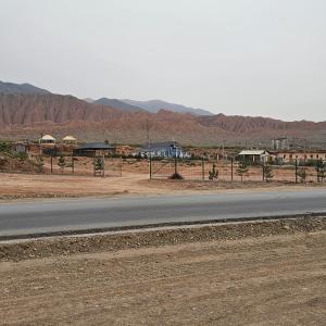 an empty road in the middle of a desert with mountains at Casabyanka in Akchiy