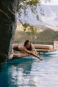 a woman laying on a raft in the water at Villa Si Era in Brataj
