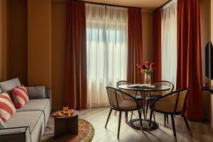 a living room with a couch and a table with chairs at Bob W Ticinese in Milan +31 photos