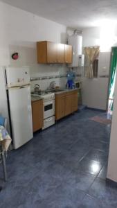 a kitchen with a white refrigerator and a stove at tu lugar para descansar in Valle Hermoso